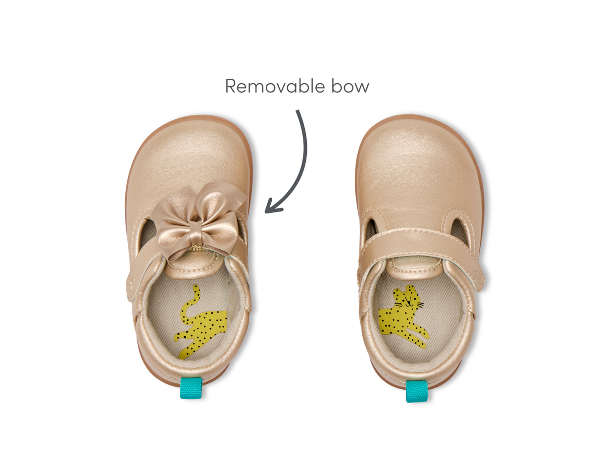 Top view of Ten Little Mini Mary Janes featuring a removable bow - Champagne Gold. Available at www.tenlittle.com