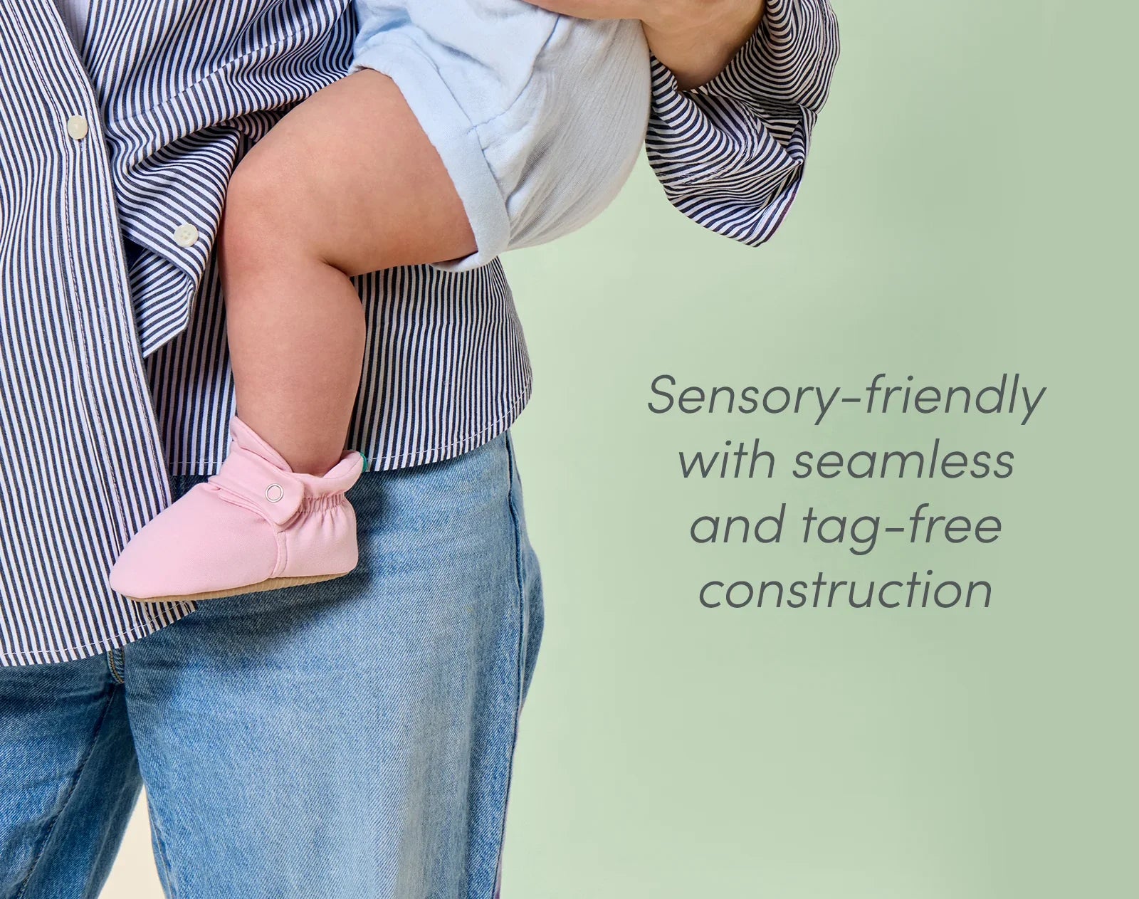 Mom holding baby wearing sensory-friendly Ten Little Everyday Baby Booties with seamless and tag-free construction - Soft Pink. Available at www.tenlittle.com