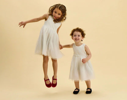 Children jumping wearing Ten Little Velvet Ballet Flats - Burgundy Red, Classic Black. Available at www.tenlittle.com