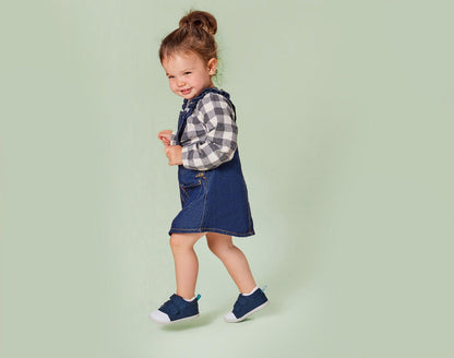 Child walking and wearing Ten Little First Walkers - Navy Blue. Available at www.tenlittle.com