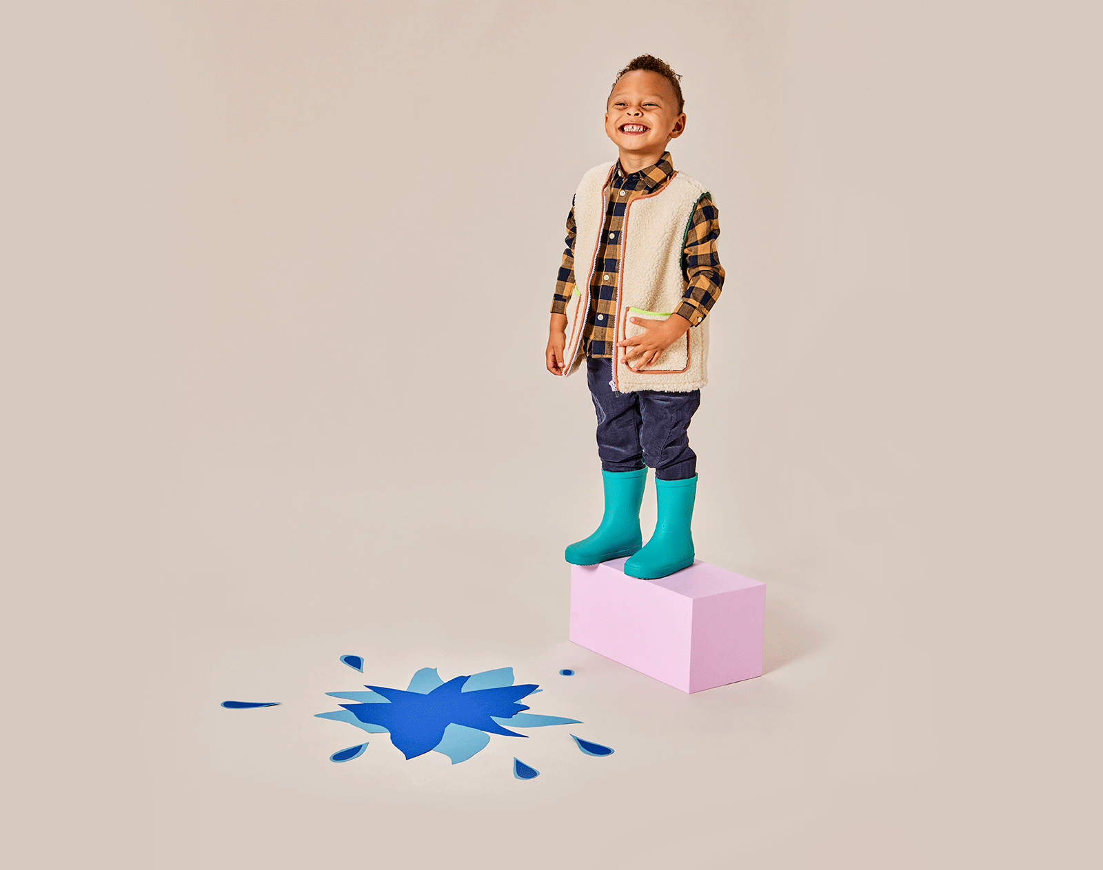 GIF boy playing and wearing Ten Little Rain Boots - Teal. Available at www.tenlittle.com