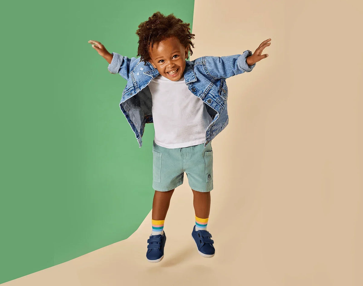 Child jumping wearing Ten Little Everyday Original - Navy Blue. Available at www.tenlittle.com