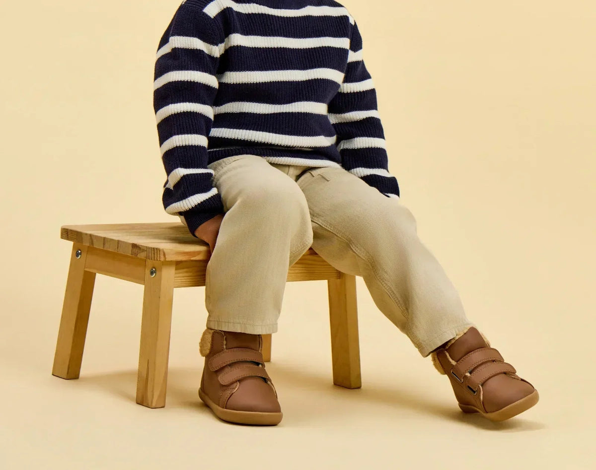 Child sitting wearing Ten Little Furry High Tops - Chestnut Brown. Available at www.tenlittle.com