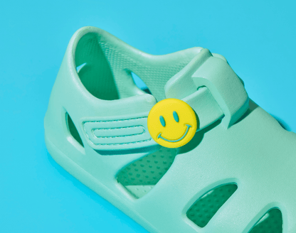 Close up of Ten Little Aqua Mint Splash Sandals with Splash Sandal Charms 2 on - Smiley. Available at www.tenlittle.com