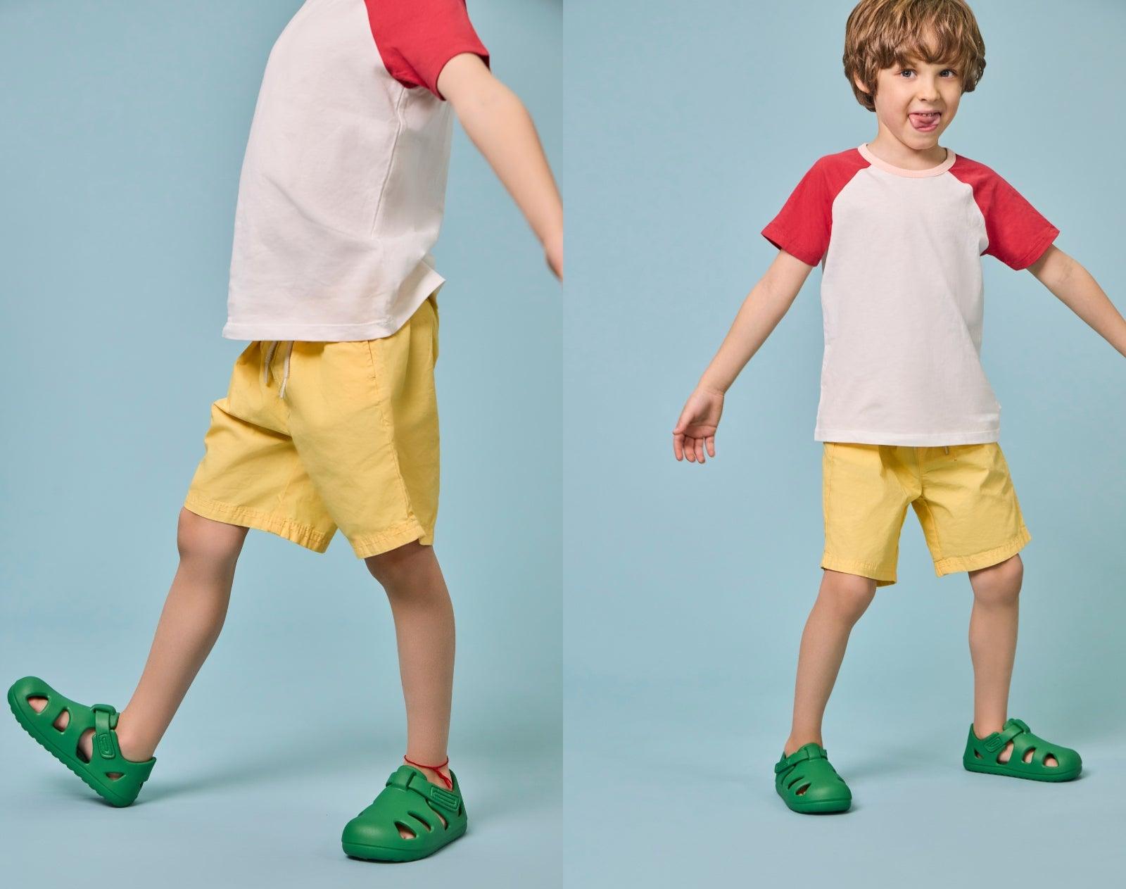 Split view of child wearing Ten Little Splash Sandals - Dino Green. Available at www.tenlittle.com