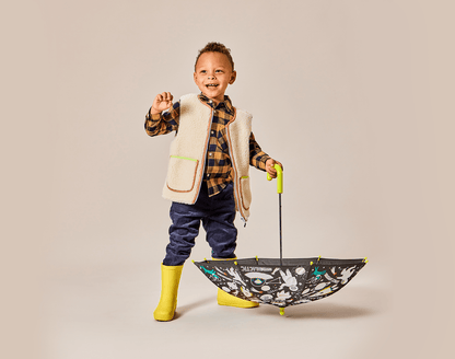 Boy holding umbrella wearing Ten Little Rain Boots - Yellow. Available at www.tenlittle.com